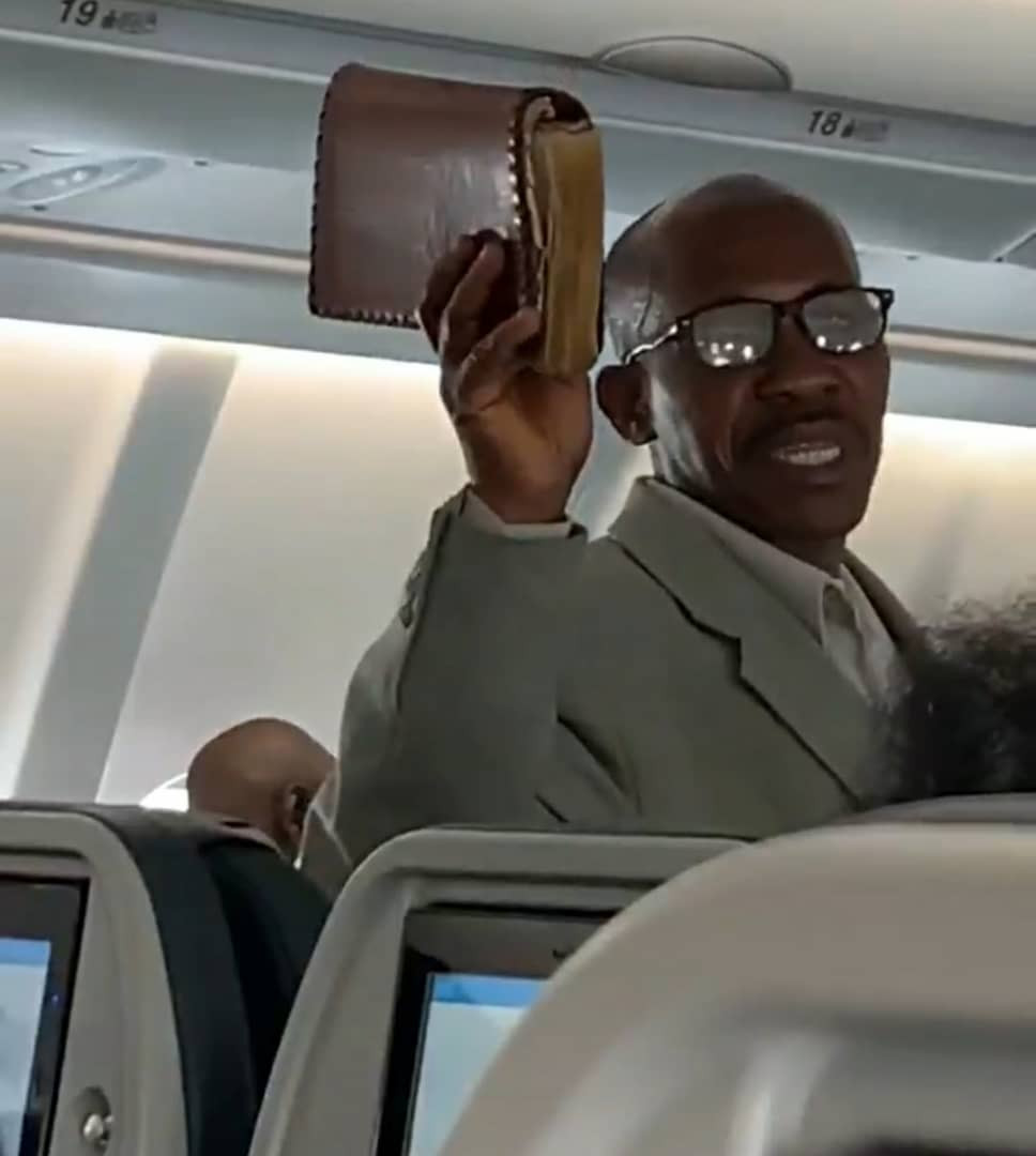 African man preaching the gospel onboard a flight