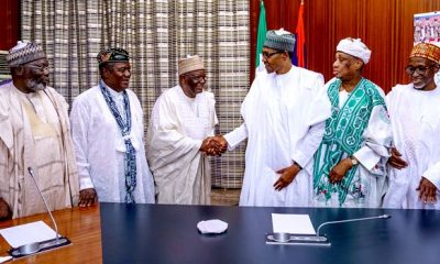 Gambari in a handshake with Buhari during a visit by former ministers who worked with the president during his military rule