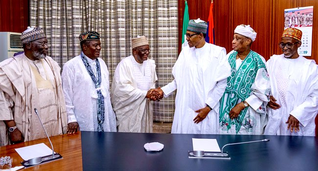 Gambari in a handshake with Buhari during a visit by former ministers who worked with the president during his military rule