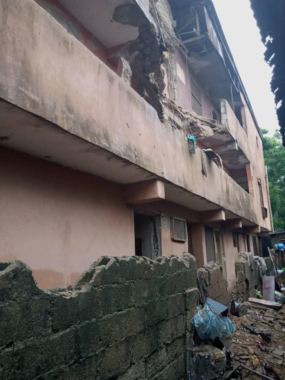 Scores escape as two-storey building collapses after heavy downpour