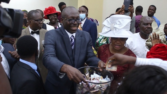 Ize-Iyamu-collecting-Thanksgiving-offering-in-the-church-