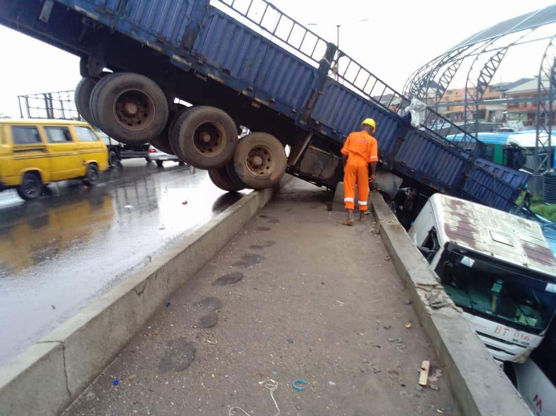 Lagos: Many escape death as Truck falls off Oshodi Bridge-TopNaija.ng