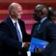 FIFA President Gianni Infantino speaks with Amaju Melvin Pinnick, President of the Nigeria Football Federation (NFF), during the 66th FIFA Congress in Mexico City