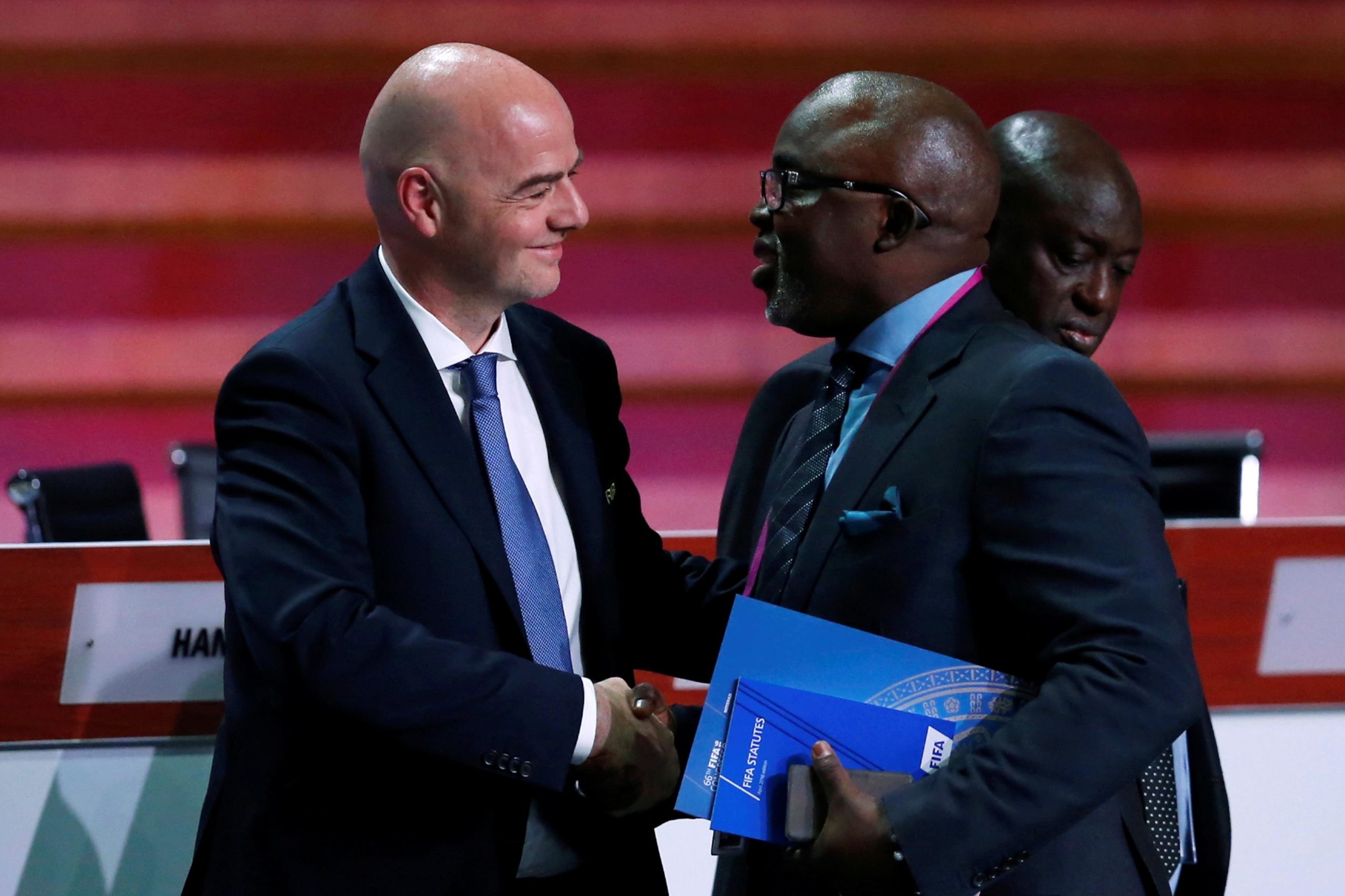 FIFA President Gianni Infantino speaks with Amaju Melvin Pinnick, President of the Nigeria Football Federation (NFF), during the 66th FIFA Congress in Mexico City